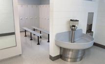 locker room featuring Terreon solid surface washfountain and lenox plastic lockers
