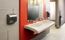 class-A office restroom with red accent wall featuring natural quartz Verge VGD-Series Lavatory System and Diplomat series washroom accessories