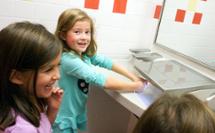 kids drying their hands at 3-in-1 Advocate AV-series sink with co-located soap water and hand drying